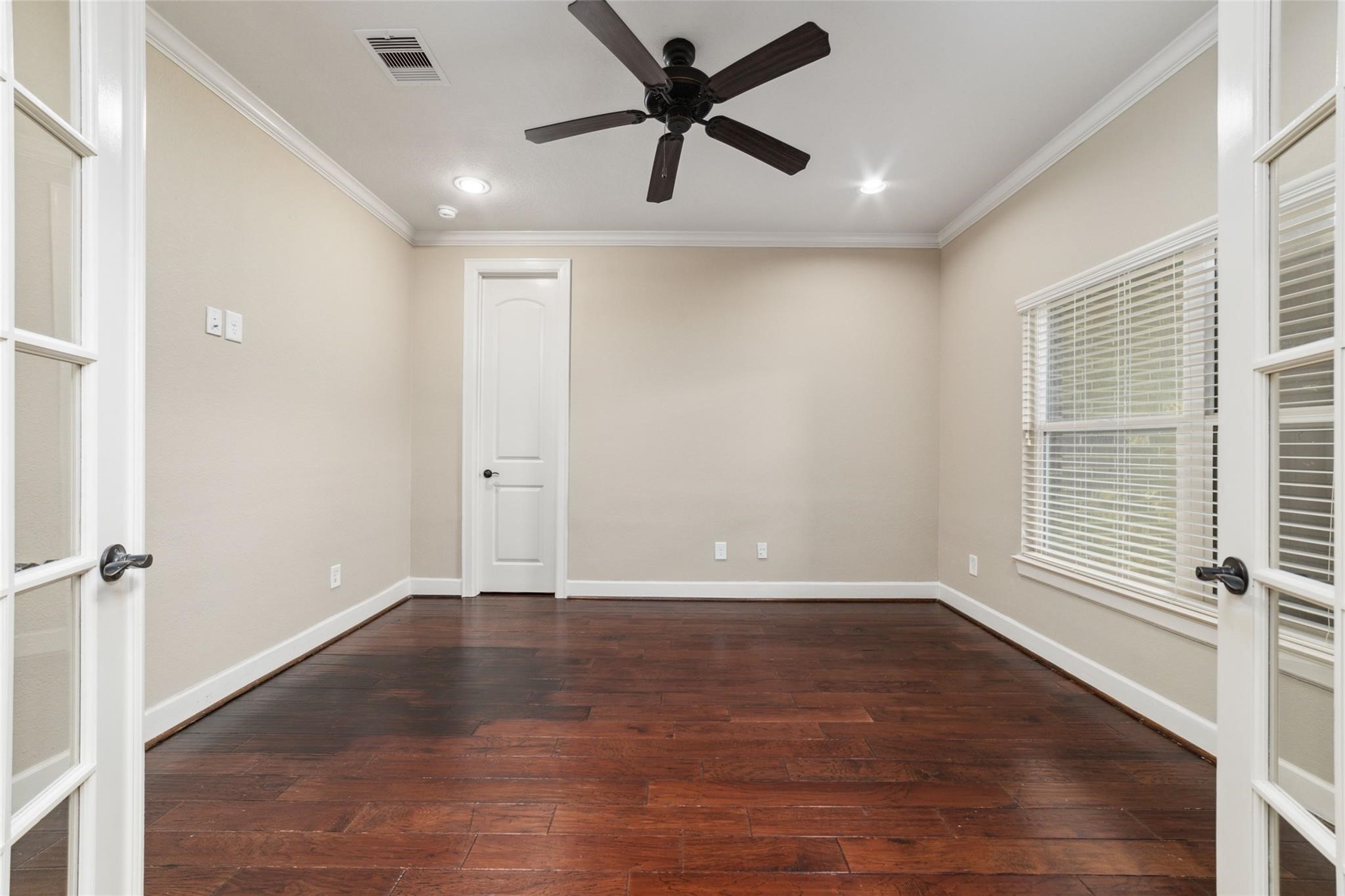 19022 Santa Elena Canyon Court Spring, TX 77388 - Photo 12 of 38 an empty room with wooden floor and windows
