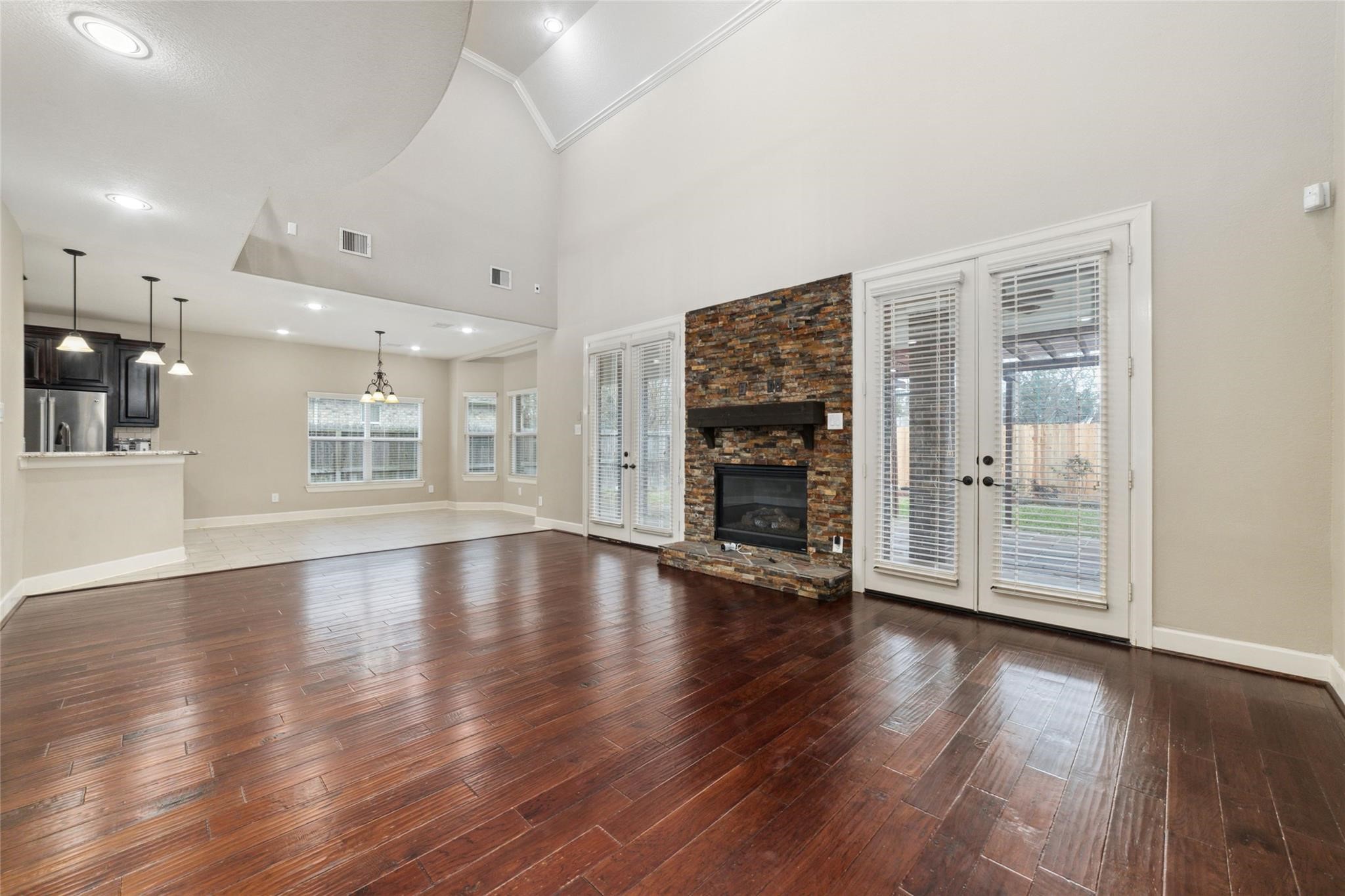 19022 Santa Elena Canyon Court Spring, TX 77388 - Photo 16 of 38 an empty room with wooden floor and a fireplace