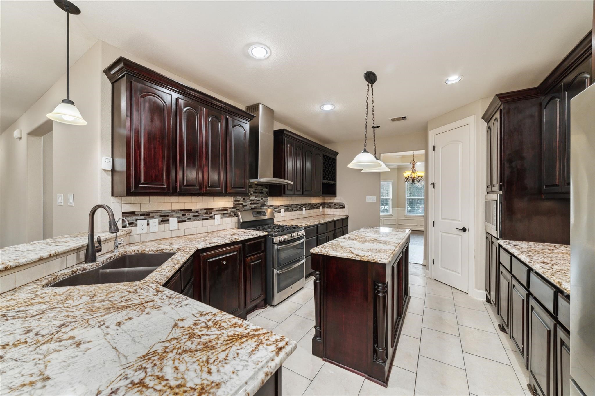 19022 Santa Elena Canyon Court Spring, TX 77388 - Photo 19 of 38 a kitchen with stainless steel appliances granite countertop a sink stove and refrigerator