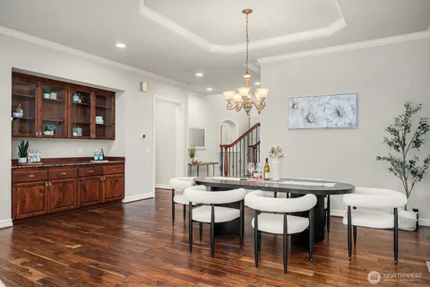 a view of a dining room with furniture wooden floor and a chandelier