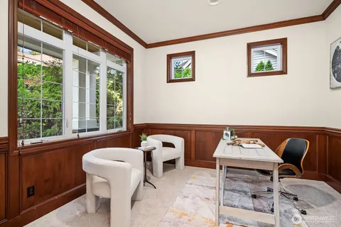 a view of a workspace with furniture and a window