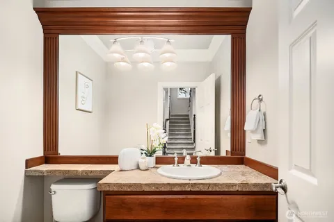 a bathroom with a granite countertop sink and a mirror