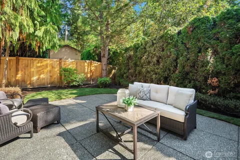 a view of a patio with couches table and chairs and potted plants