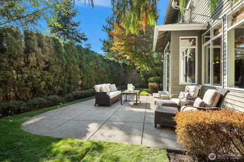 a view of a patio with couches and a table and chairs with garden view