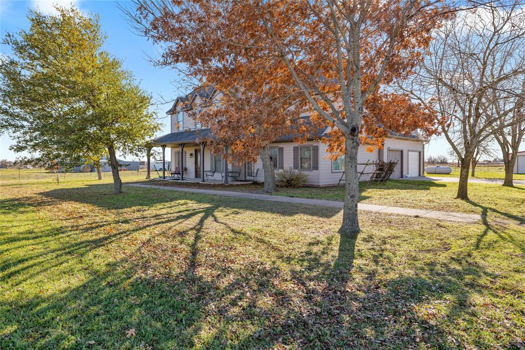 7373 Michael Road Sanger, TX 76266 - Photo 1 of 1 View of front facade featuring a porch, a garage, and a front yard