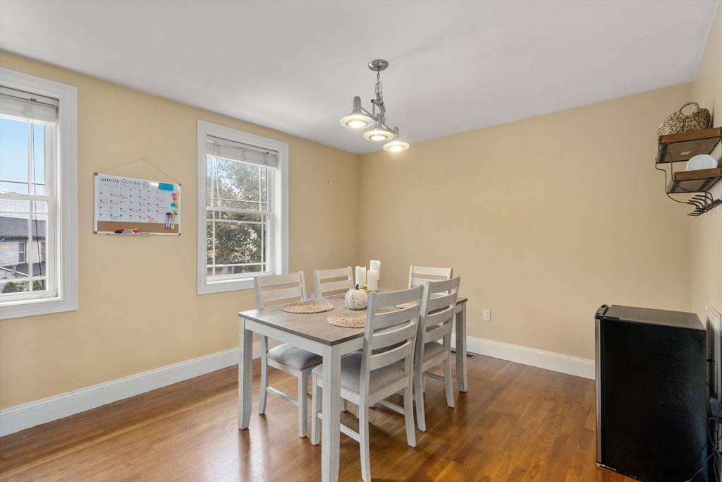 62 Redfield Street, Unit 62 Boston, MA 02122 - Photo 22 of 30 a view of a dining room with furniture and wooden floor