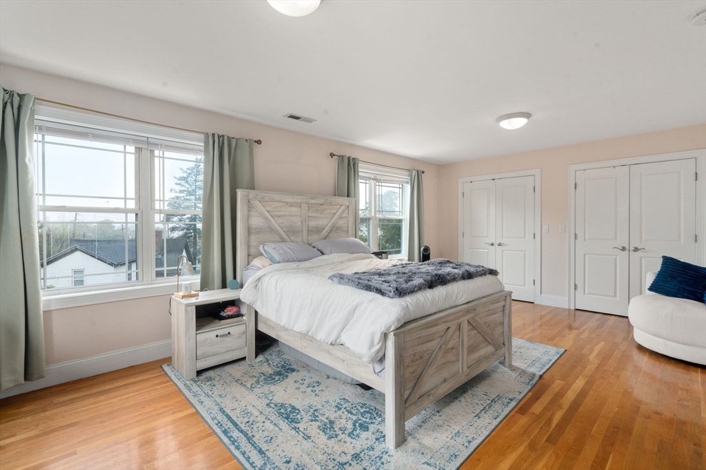 62 Redfield Street, Unit 62 Boston, MA 02122 - Photo 10 of 30 a spacious bedroom with a bed and a large window