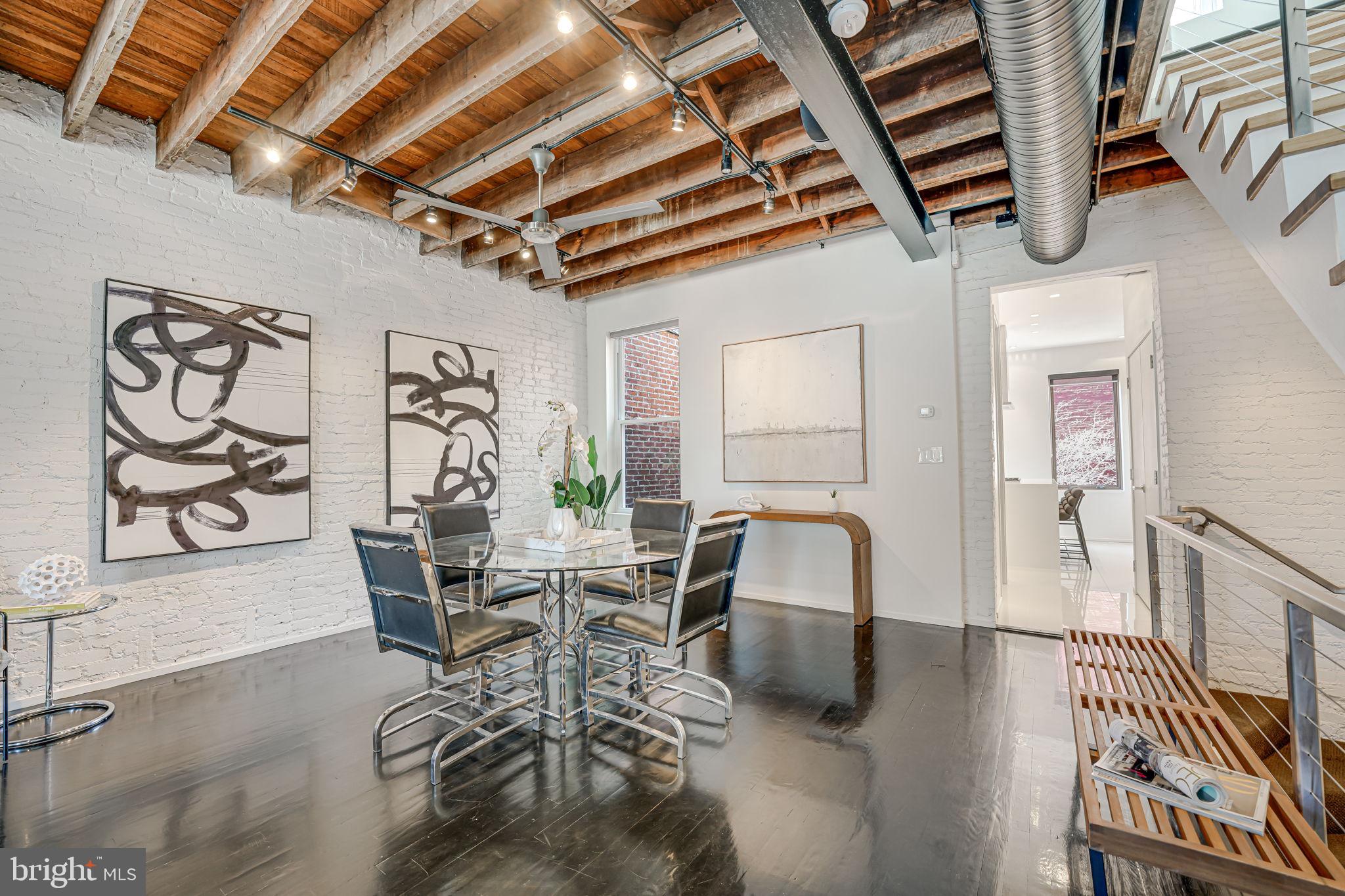 1836 9th Street Northwest, Unit 2 Washington, DC 20001 - Photo 11 of 30 a dining room with furniture a rug a fireplace and wooden floor