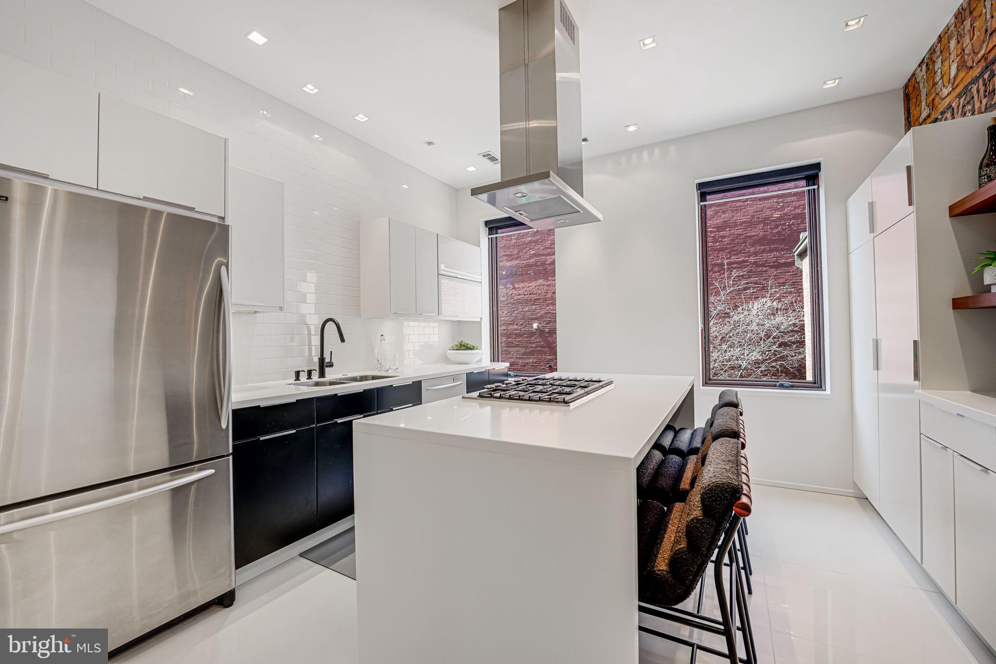 1836 9th Street Northwest, Unit 2 Washington, DC 20001 - Photo 14 of 30 a kitchen with stainless steel appliances a refrigerator and a stove top oven