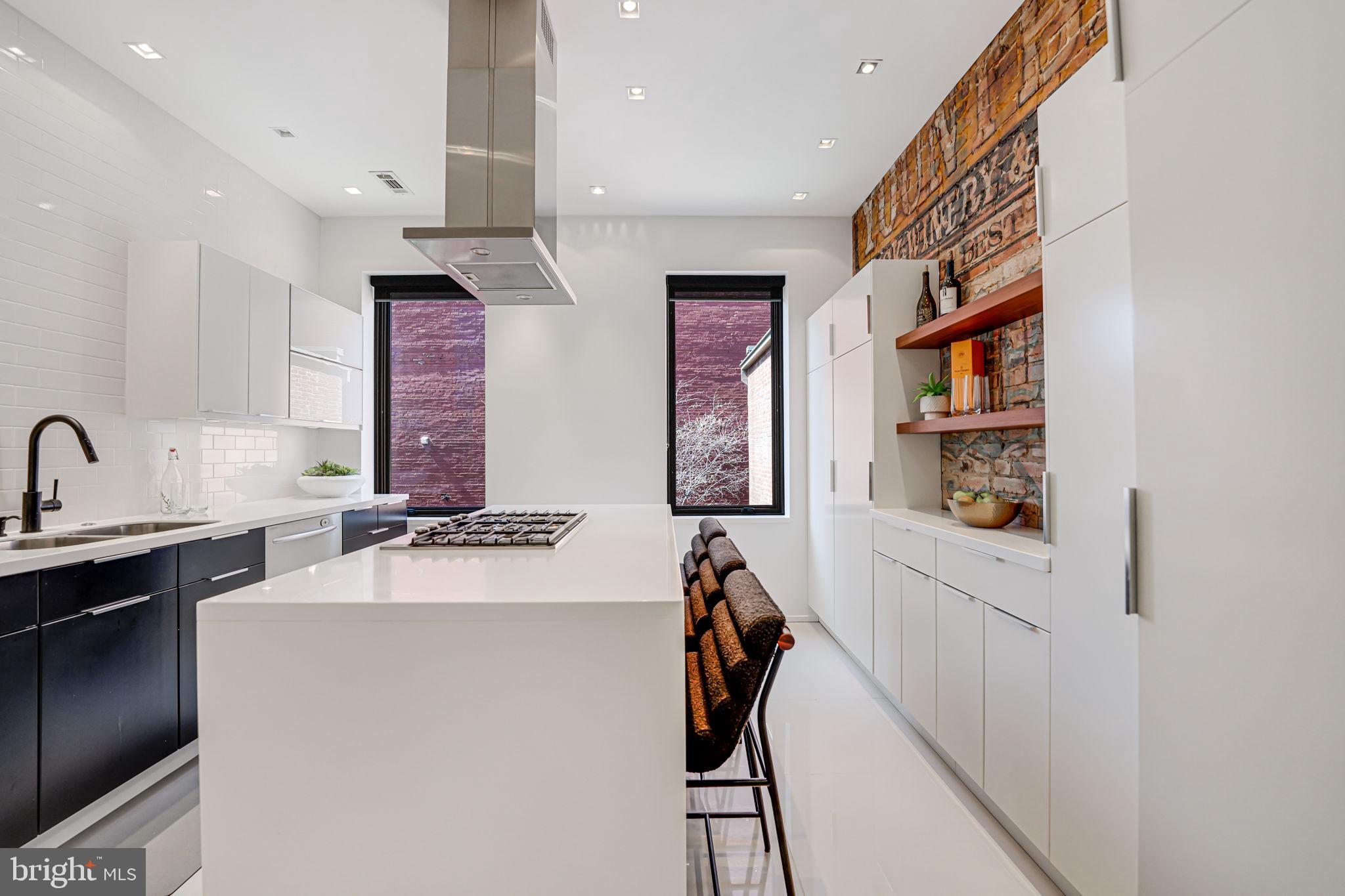 1836 9th Street Northwest, Unit 2 Washington, DC 20001 - Photo 16 of 30 a kitchen with stainless steel appliances a sink stove and cabinets