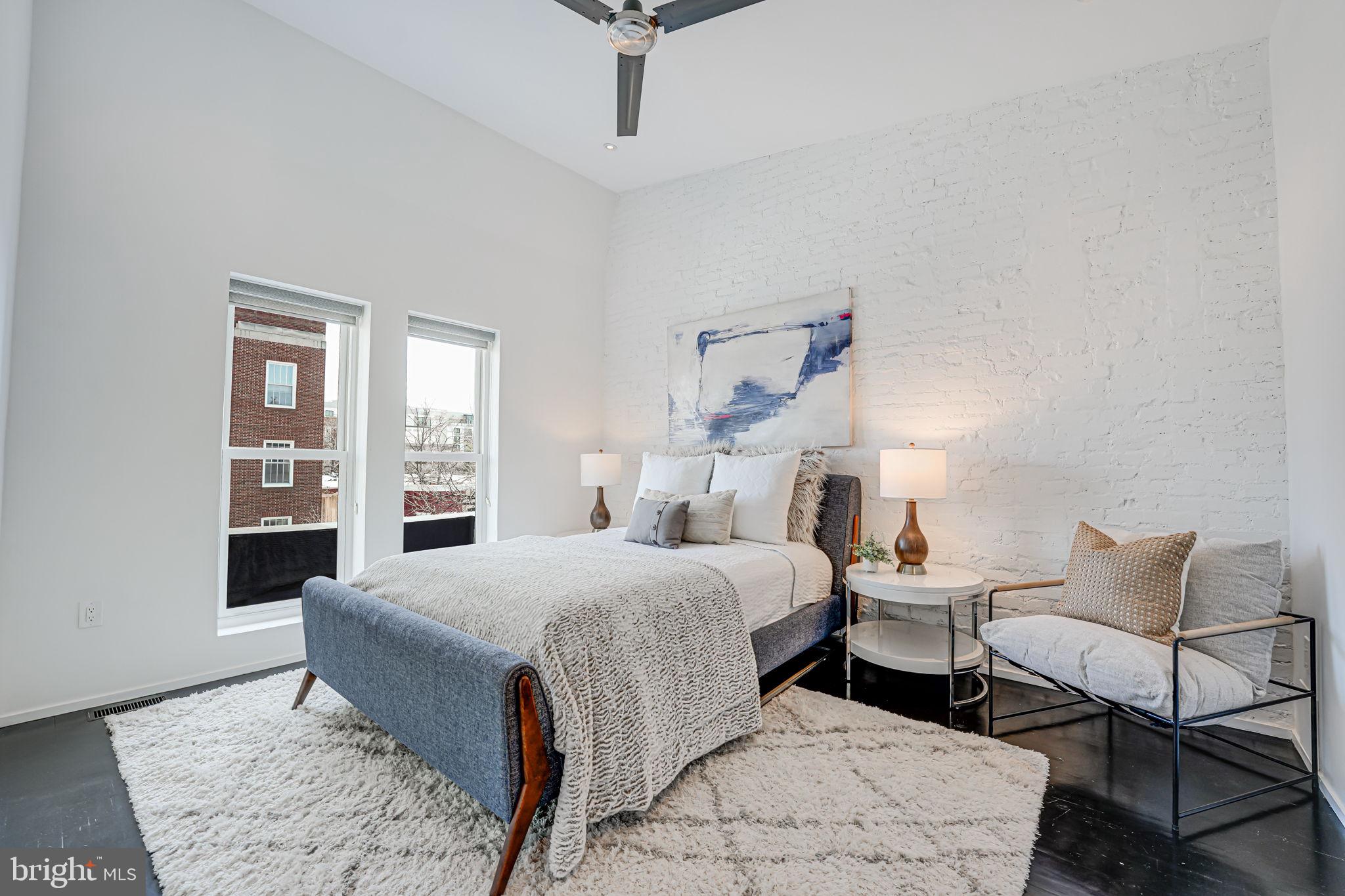 1836 9th Street Northwest, Unit 2 Washington, DC 20001 - Photo 24 of 30 a bedroom with a bed and wooden floor