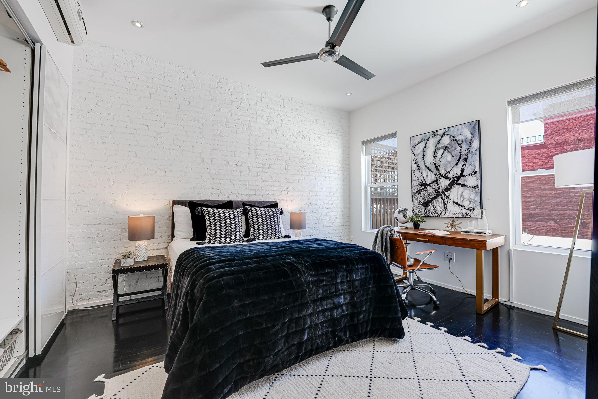 1836 9th Street Northwest, Unit 2 Washington, DC 20001 - Photo 25 of 30 a bedroom with a bed and wooden floor