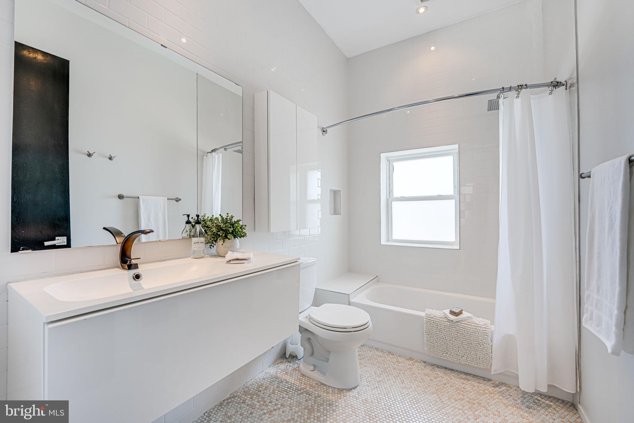 1836 9th Street Northwest, Unit 2 Washington, DC 20001 - Photo 27 of 30 a bathroom with a sink a toilet and shower