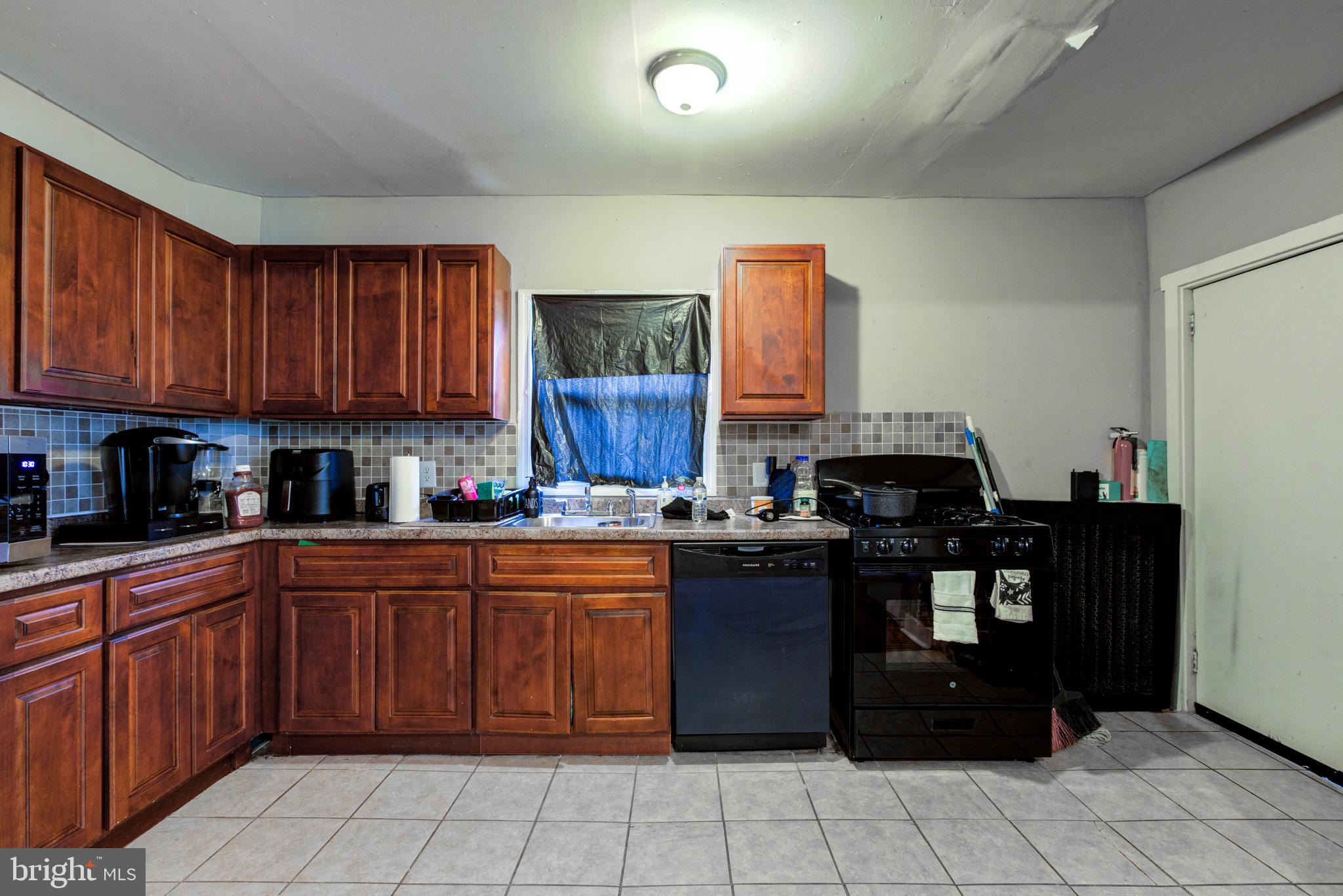 6209 Carpenter Street Philadelphia, PA 19143 - Photo 21 of 44 a kitchen with a sink and cabinets