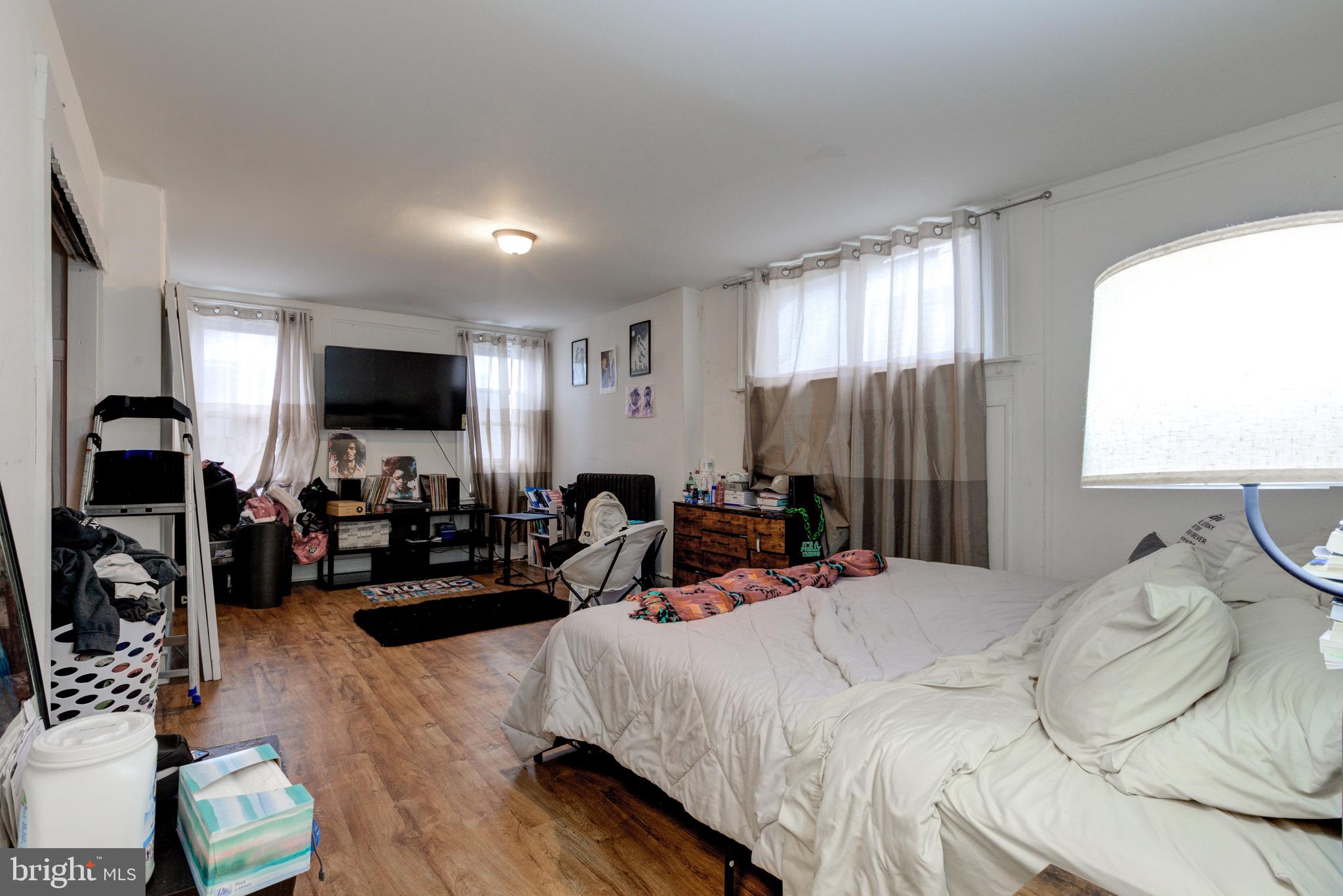 6209 Carpenter Street Philadelphia, PA 19143 - Photo 24 of 44 a bedroom with furniture a bed and a flat screen tv