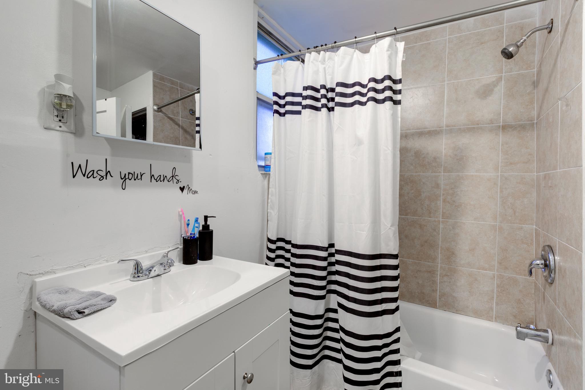 6209 Carpenter Street Philadelphia, PA 19143 - Photo 28 of 44 a bathroom with a sink and a mirror
