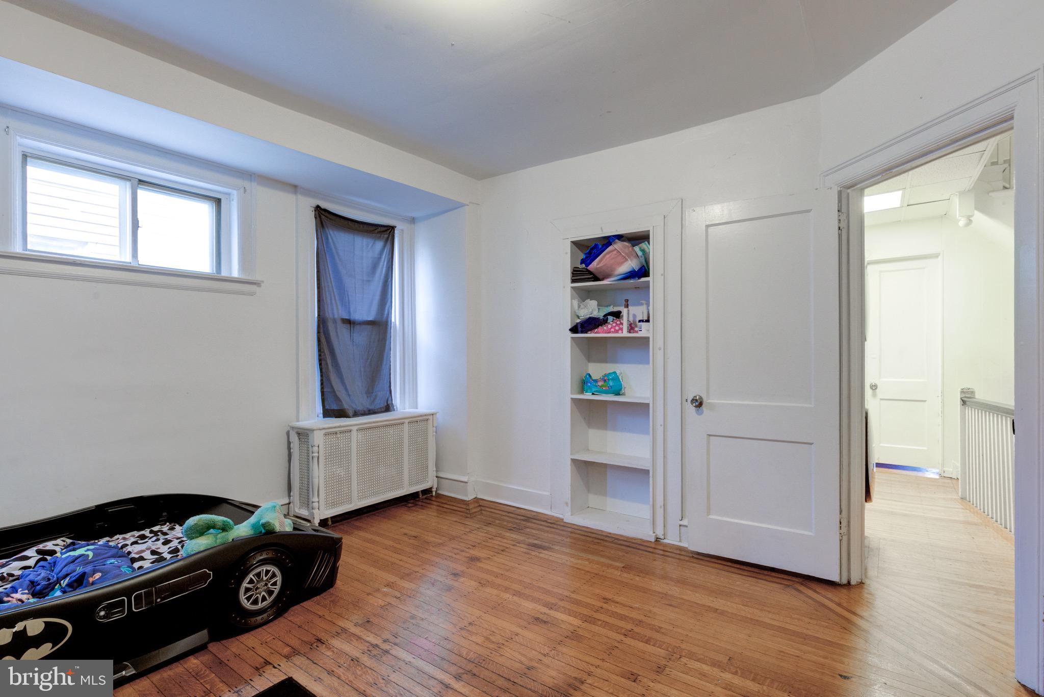 6209 Carpenter Street Philadelphia, PA 19143 - Photo 30 of 44 a bedroom with furniture and a window