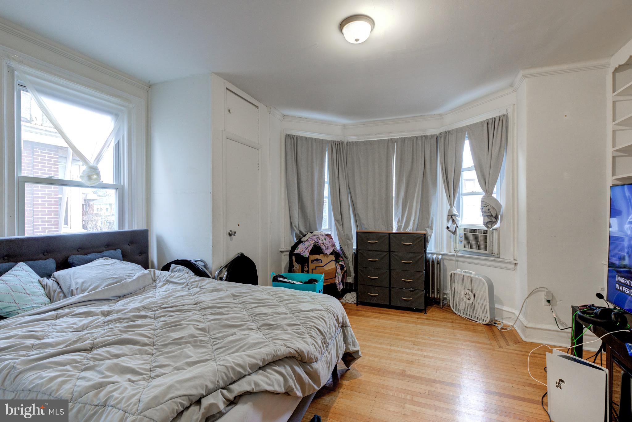 6209 Carpenter Street Philadelphia, PA 19143 - Photo 31 of 44 a bedroom with a bed and wooden floor