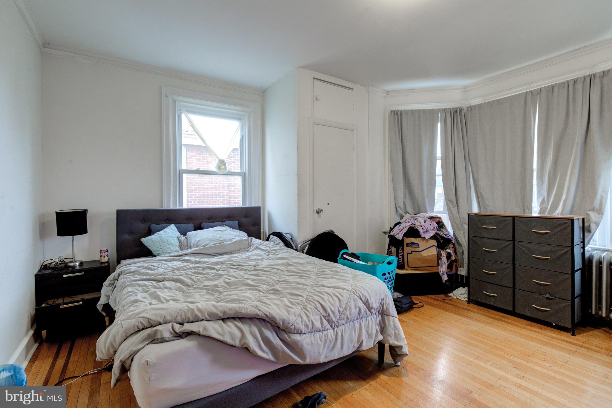 6209 Carpenter Street Philadelphia, PA 19143 - Photo 32 of 44 a bedroom with a bed and wooden floor