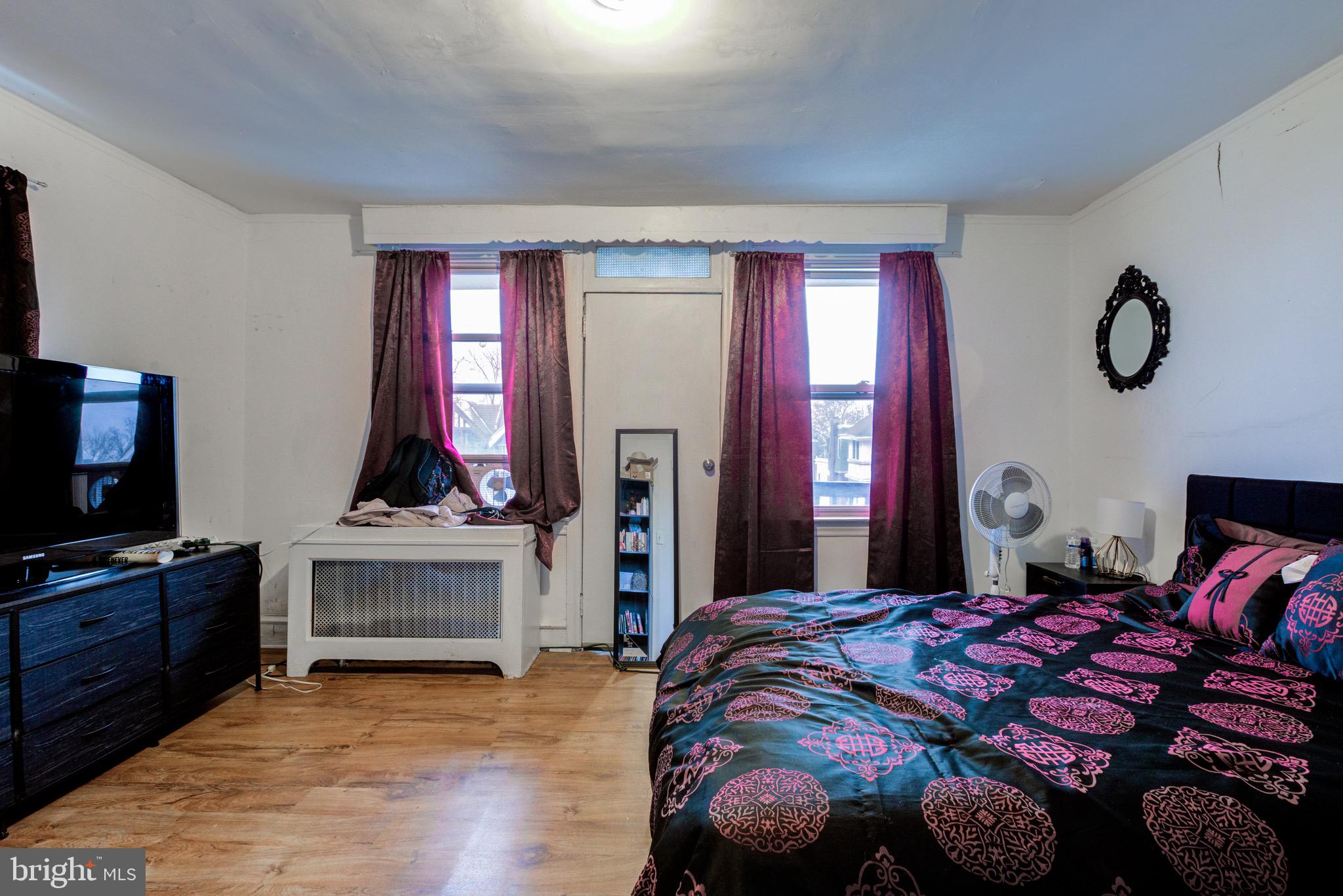 6209 Carpenter Street Philadelphia, PA 19143 - Photo 34 of 44 a bedroom with a bed and a flat screen tv