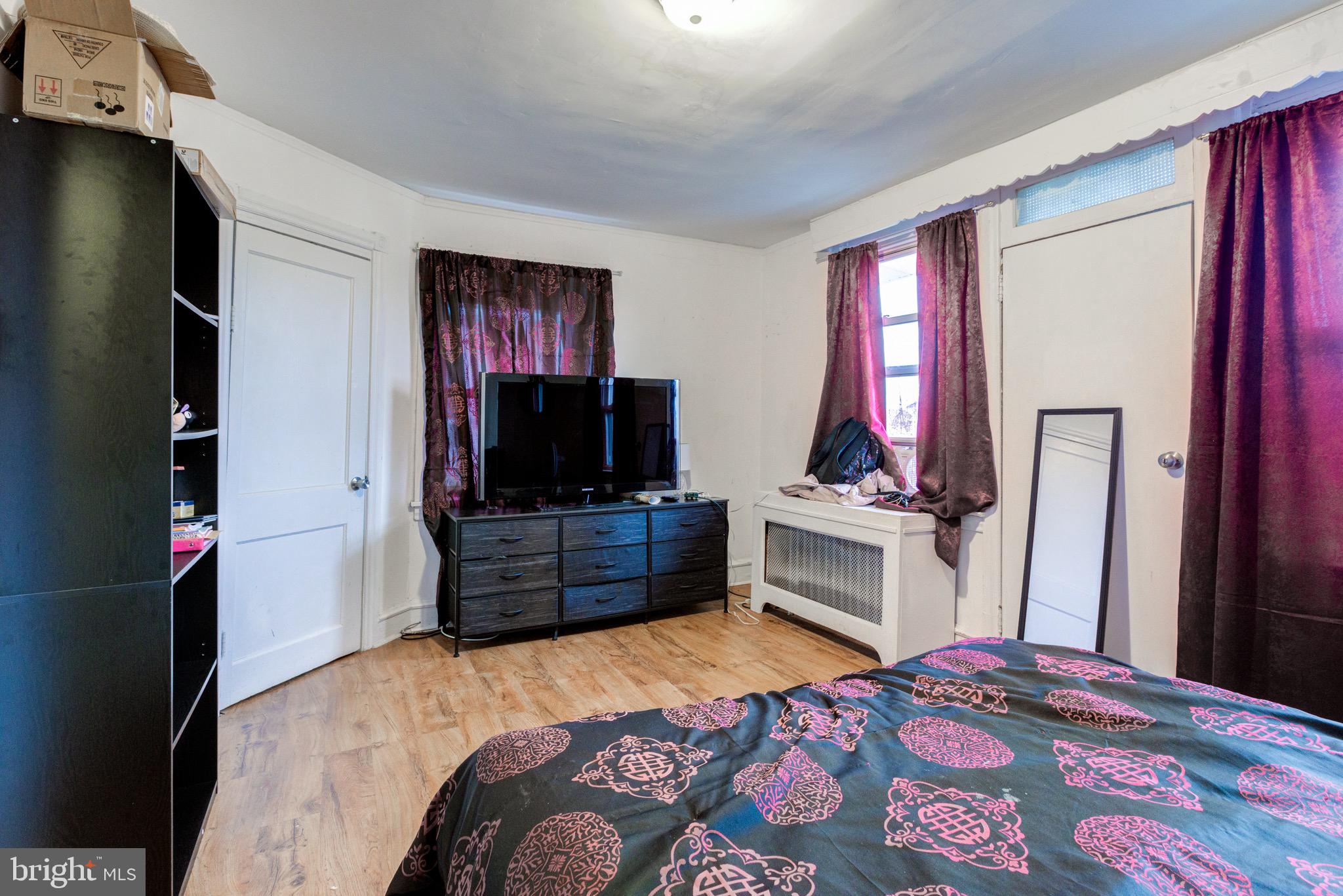 6209 Carpenter Street Philadelphia, PA 19143 - Photo 35 of 44 a bedroom with a bed and flat screen tv
