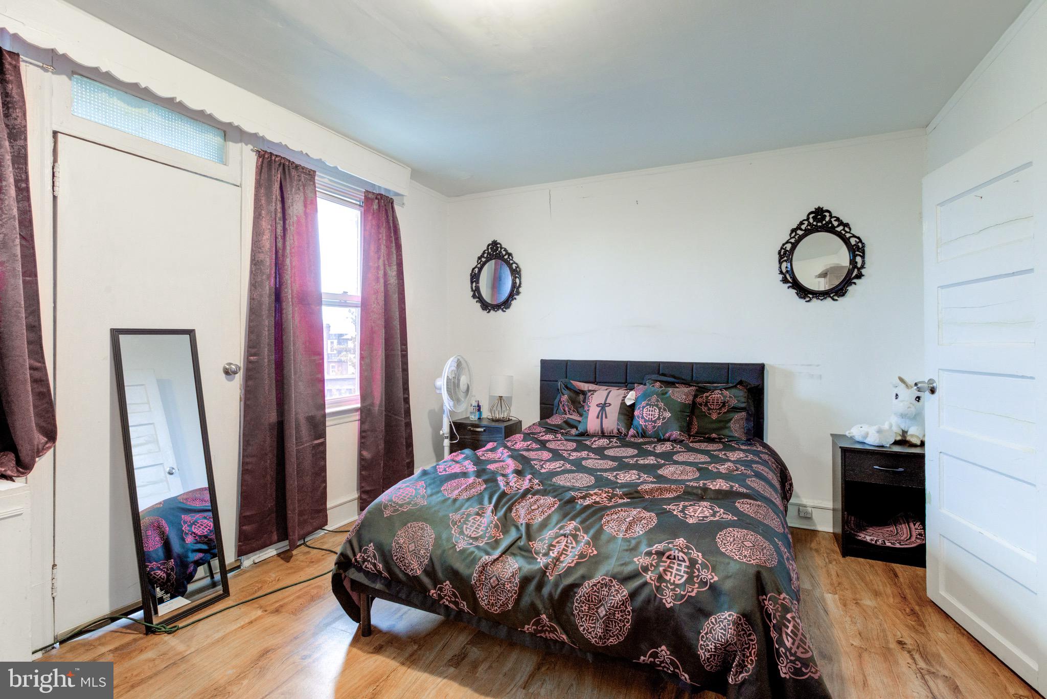 6209 Carpenter Street Philadelphia, PA 19143 - Photo 36 of 44 a bedroom with a bed and a mirror