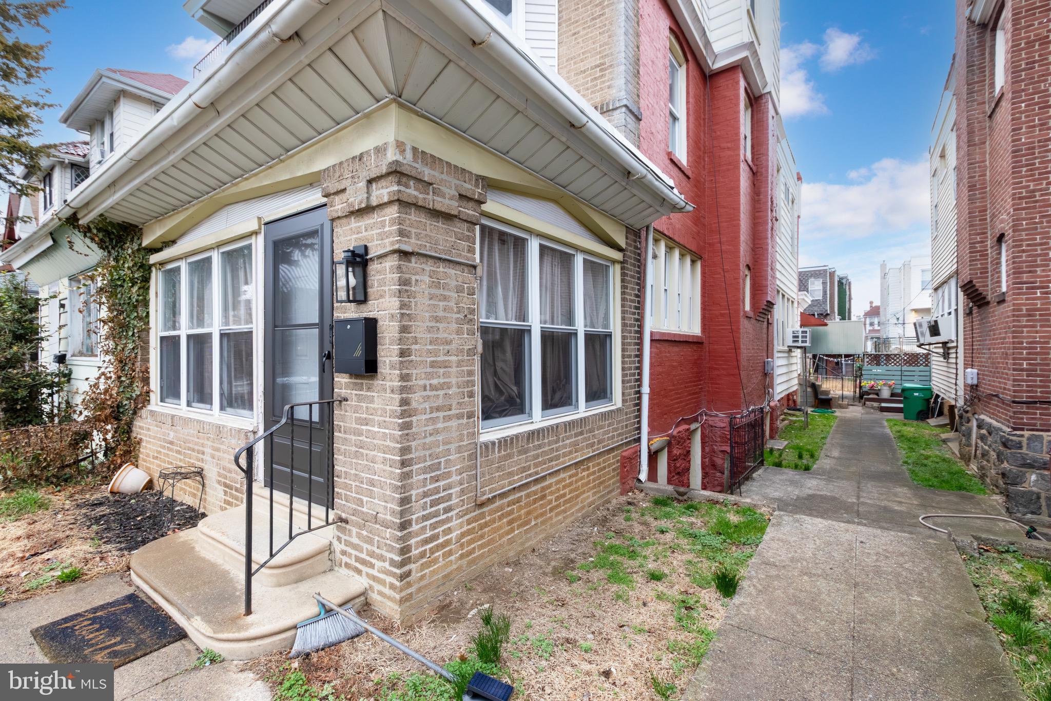 6209 Carpenter Street Philadelphia, PA 19143 - Photo 4 of 44 a view of a brick house with many windows