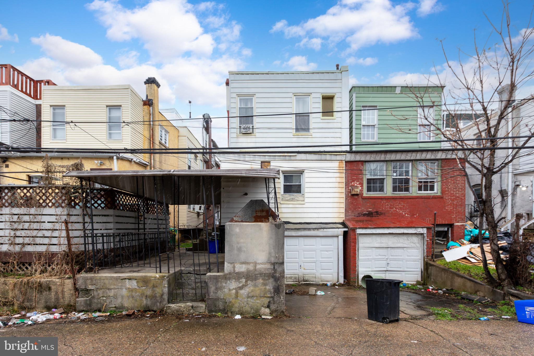 6209 Carpenter Street Philadelphia, PA 19143 - Photo 41 of 44 a front view of a building with glass windows and garage