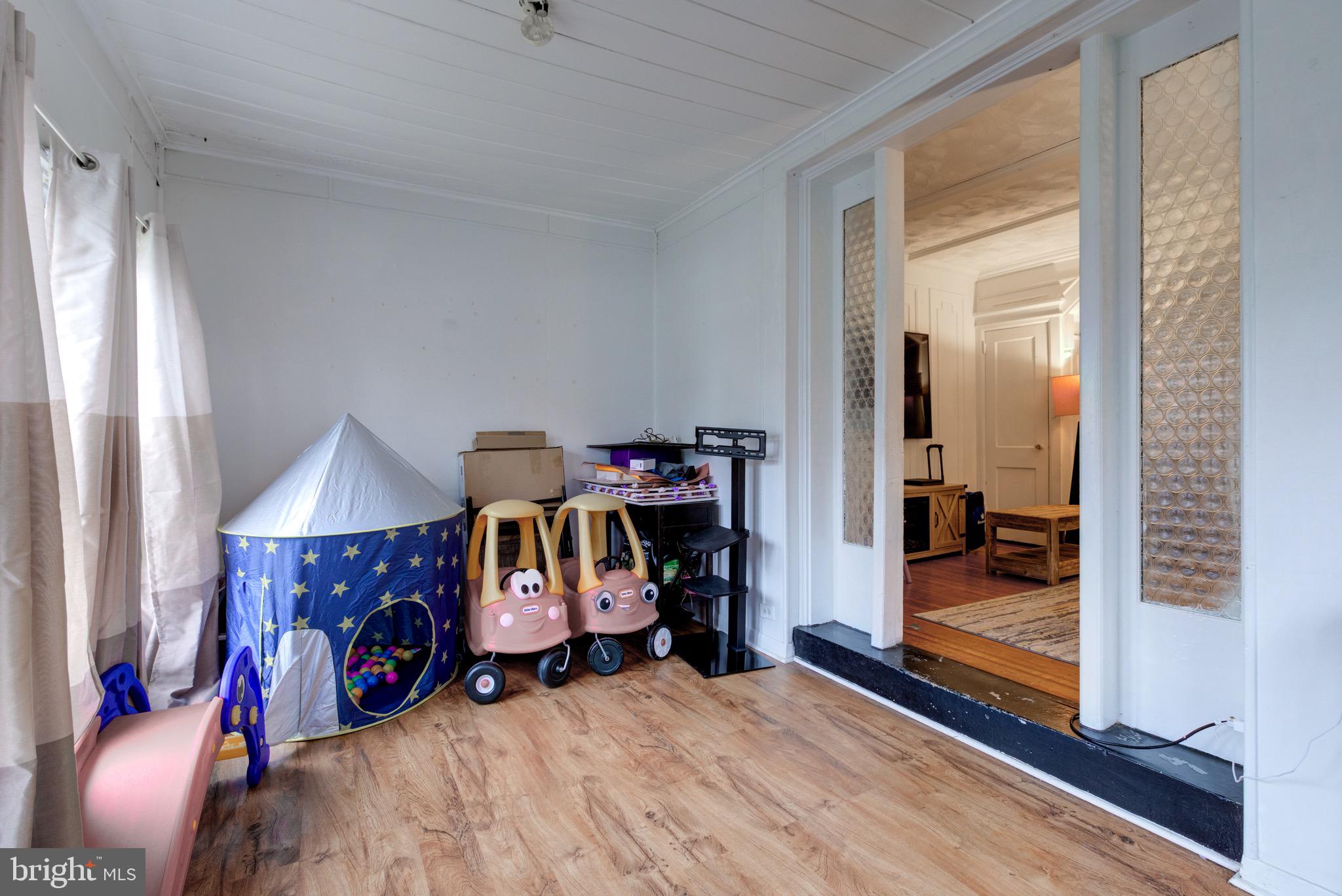 6209 Carpenter Street Philadelphia, PA 19143 - Photo 5 of 44 a view of an empty room with wooden floor and a window