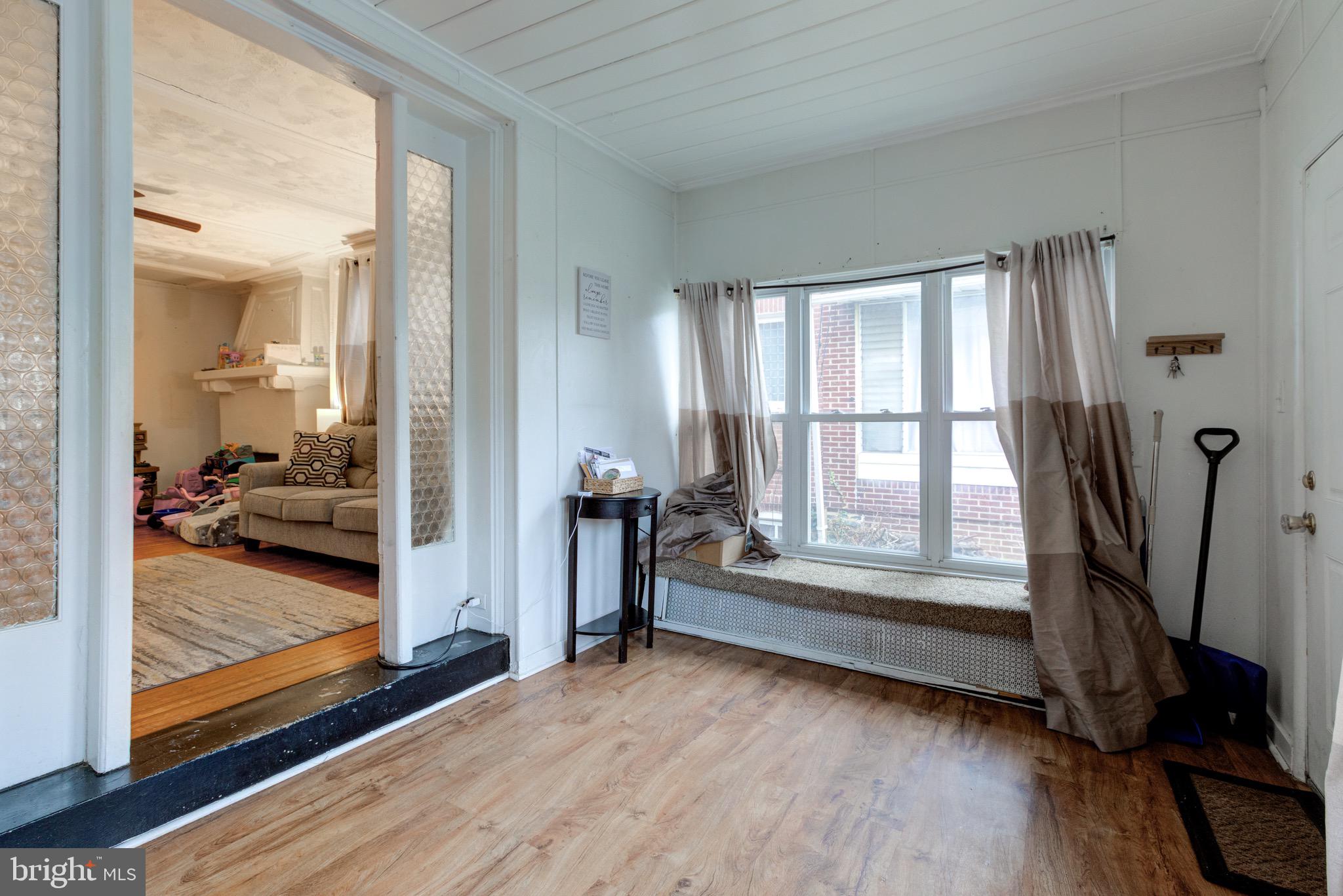6209 Carpenter Street Philadelphia, PA 19143 - Photo 6 of 44 a view of front door and bedroom with wooden floor