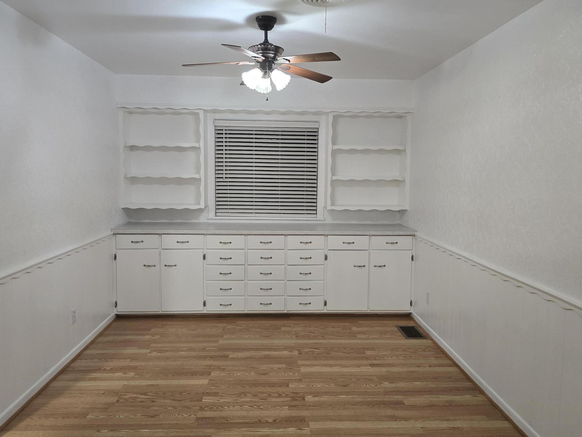 2229 South 6th Street Lamesa, TX 79331 - Photo 9 of 27 wooden floor in an empty room with a window