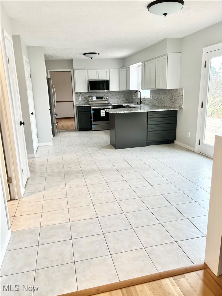 15317 Strader Road East Liverpool, OH 43920 - Photo 7 of 23 Kitchen featuring tasteful backsplash, sink, white cabinets, and appliances with stainless steel finishes