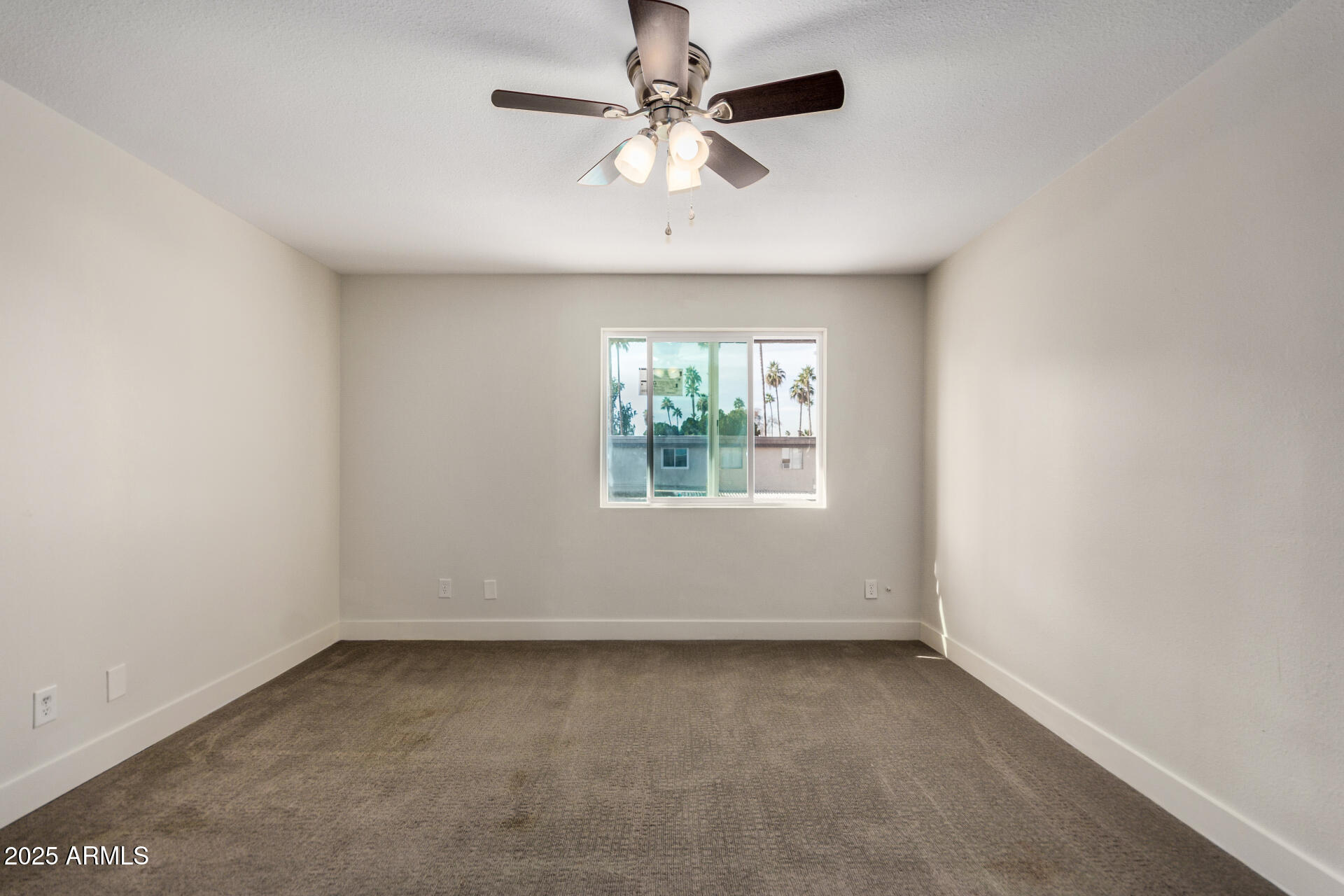 7126 North 19th Avenue, Unit 169 Phoenix, AZ 85021 - Photo 14 of 30 an empty room with a window and a fan