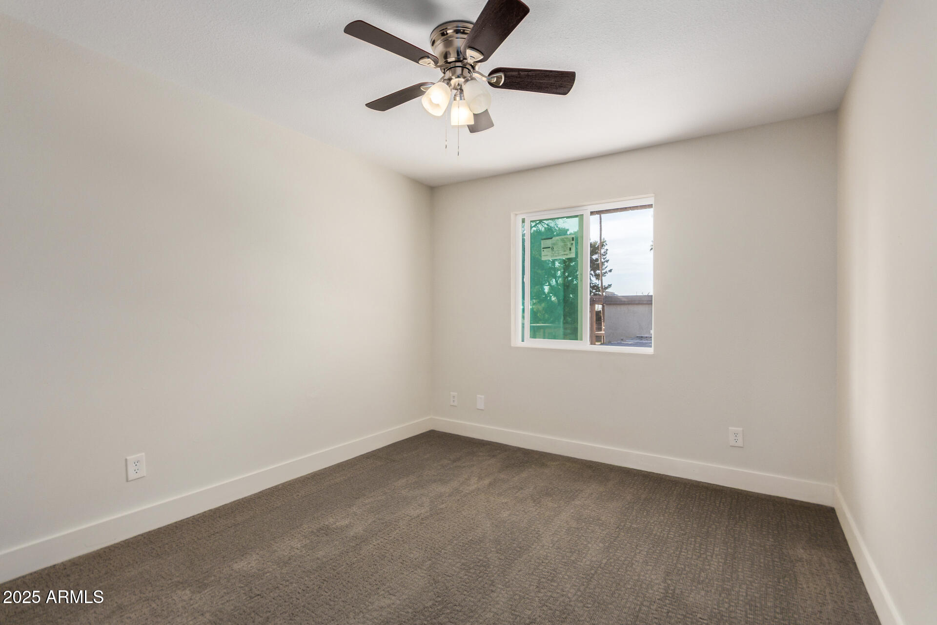 7126 North 19th Avenue, Unit 169 Phoenix, AZ 85021 - Photo 19 of 30 an empty room with a window and a fan