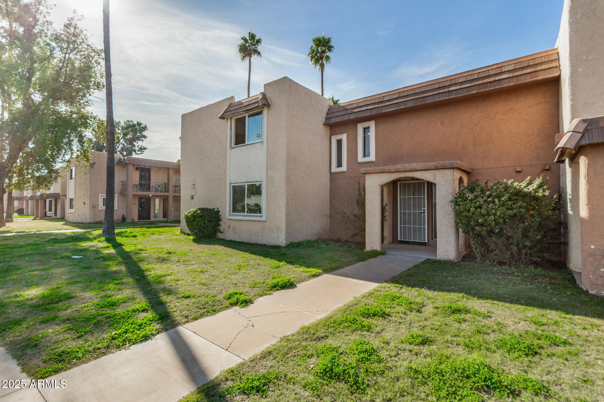 7126 North 19th Avenue, Unit 169 Phoenix, AZ 85021 - Photo 2 of 30 a front view of a house with garden