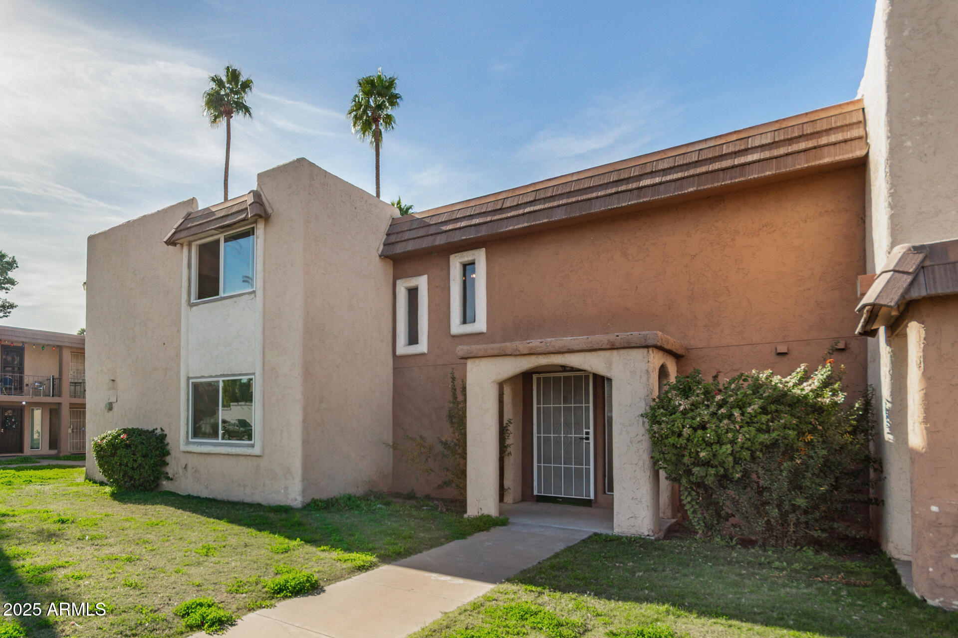 7126 North 19th Avenue, Unit 169 Phoenix, AZ 85021 - Photo 3 of 30 a front view of a house with garden