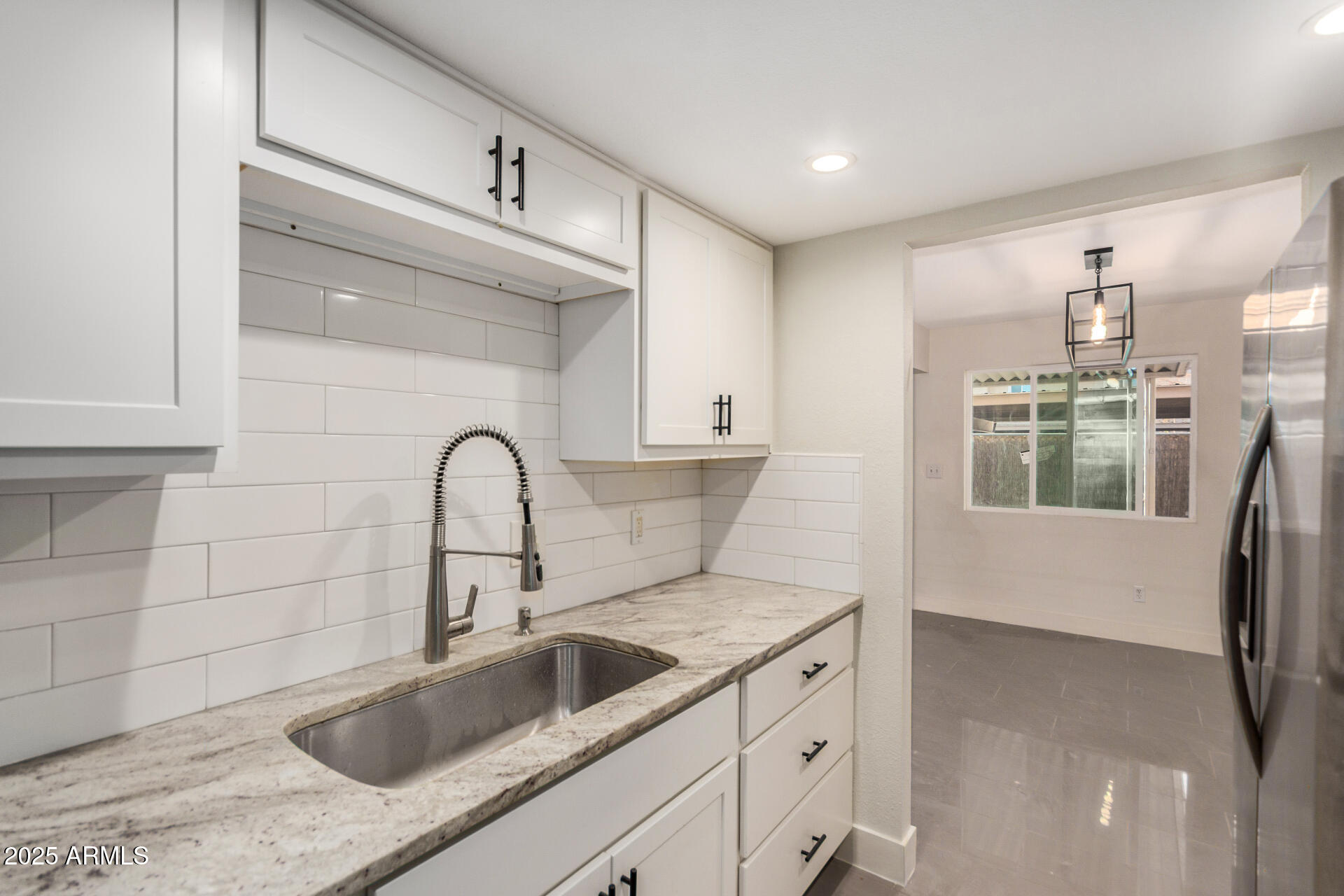 7126 North 19th Avenue, Unit 169 Phoenix, AZ 85021 - Photo 9 of 30 a kitchen with a sink and a refrigerator
