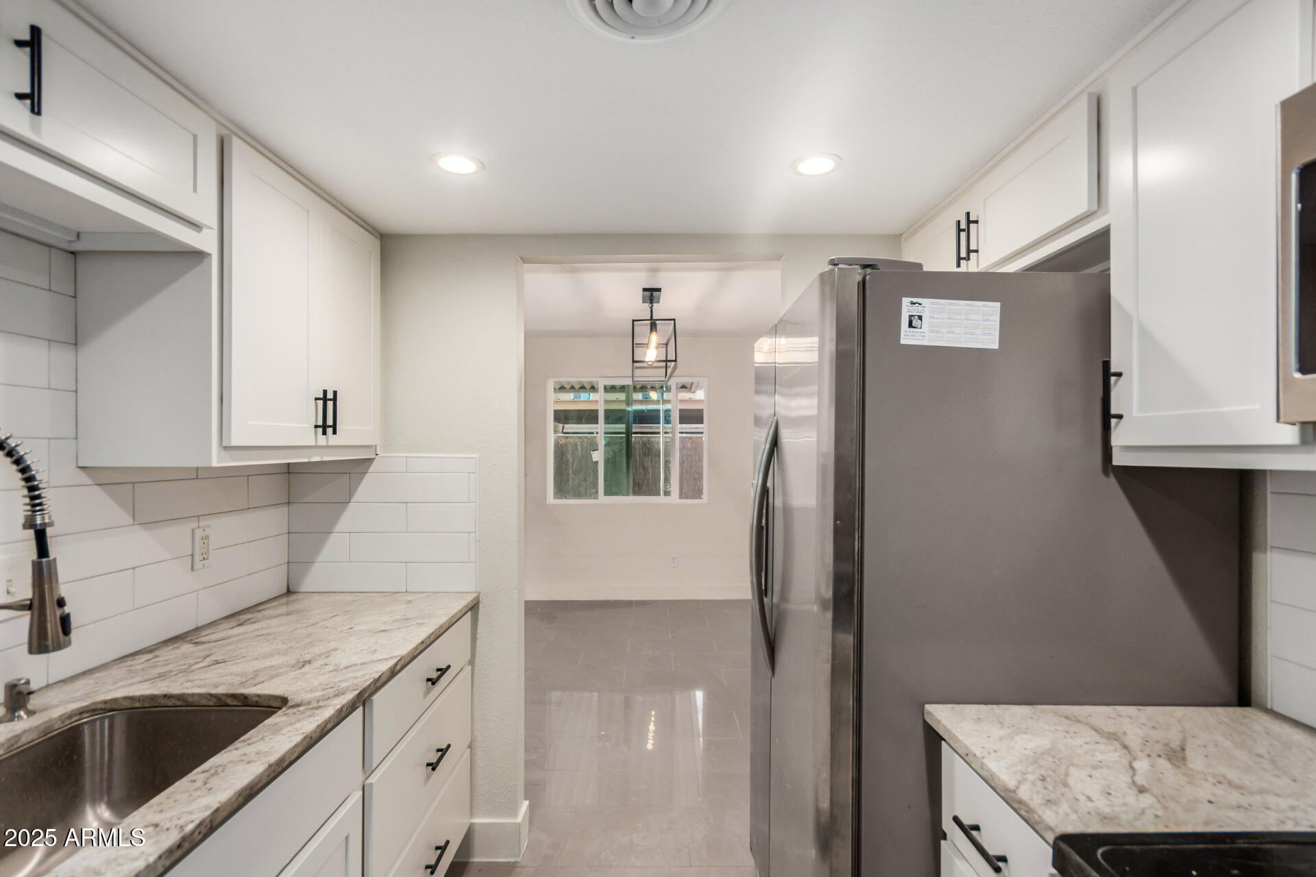 7126 North 19th Avenue, Unit 169 Phoenix, AZ 85021 - Photo 10 of 30 a kitchen with a sink dishwasher a refrigerator and cabinets