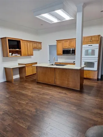 a kitchen with granite countertop a sink and a stove top oven