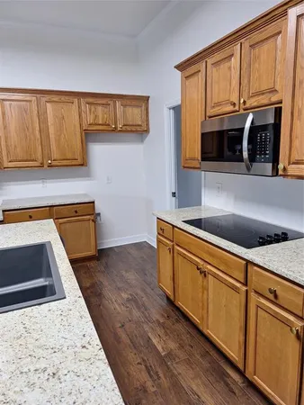 a living room with hard wood floors and a large window