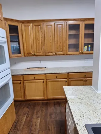 a kitchen with granite countertop a sink and a stove