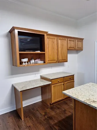a kitchen with granite countertop a sink and a stove top oven