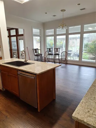 a living room with hard wood floors and a large window