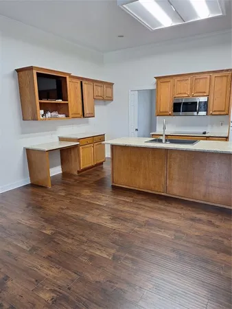 a living room with stainless steel appliances kitchen island granite countertop a stove top oven