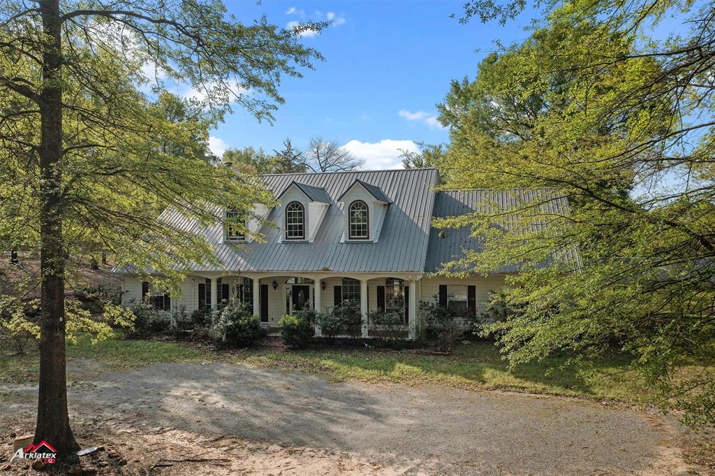 15280 Wynn School Road Hosston, LA 71043 - Photo 2 of 27 Cape cod-style house with metal roof and a porch