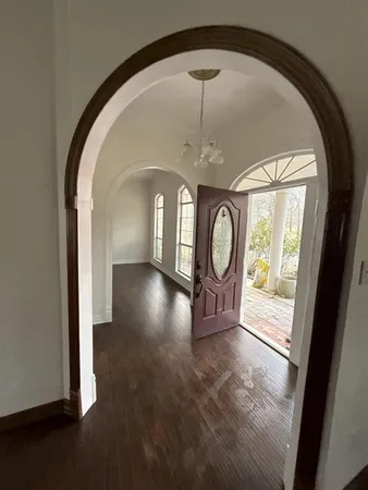 a kitchen with stainless steel appliances wooden floor and a refrigerator