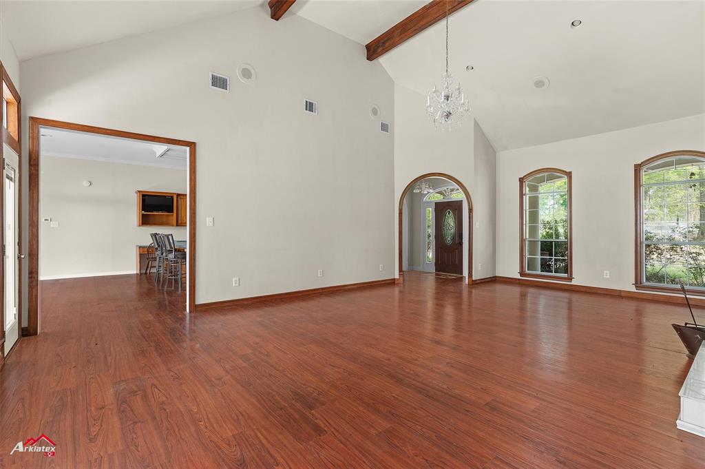 15280 Wynn School Road Hosston, LA 71043 - Photo 6 of 27 Unfurnished living room featuring visible vents, a chandelier, and wood finished floors