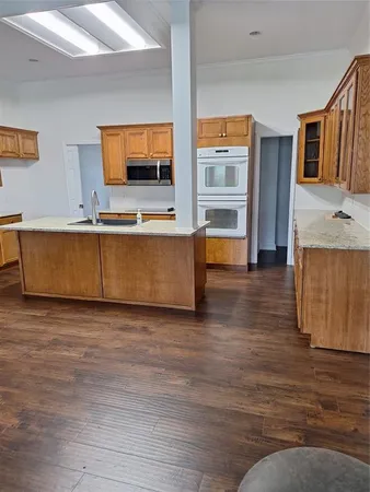 a kitchen with stainless steel appliances granite countertop a sink and stove top oven