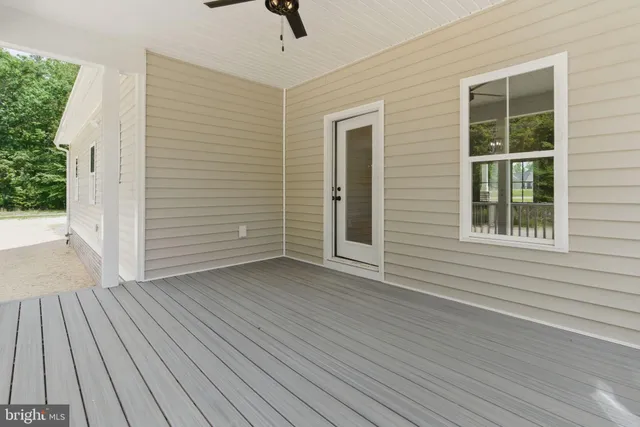 a view of a swimming pool with a bench and trees