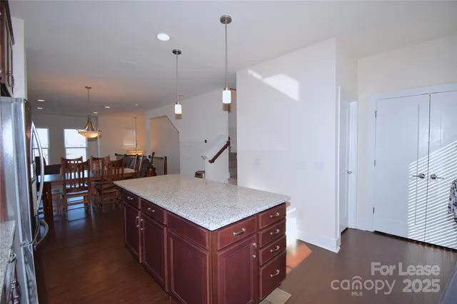 a kitchen with a sink a counter top space and stainless steel appliances